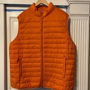 Orange puffy vest.  Xxl hangs past stomach to top off hips. Nice length